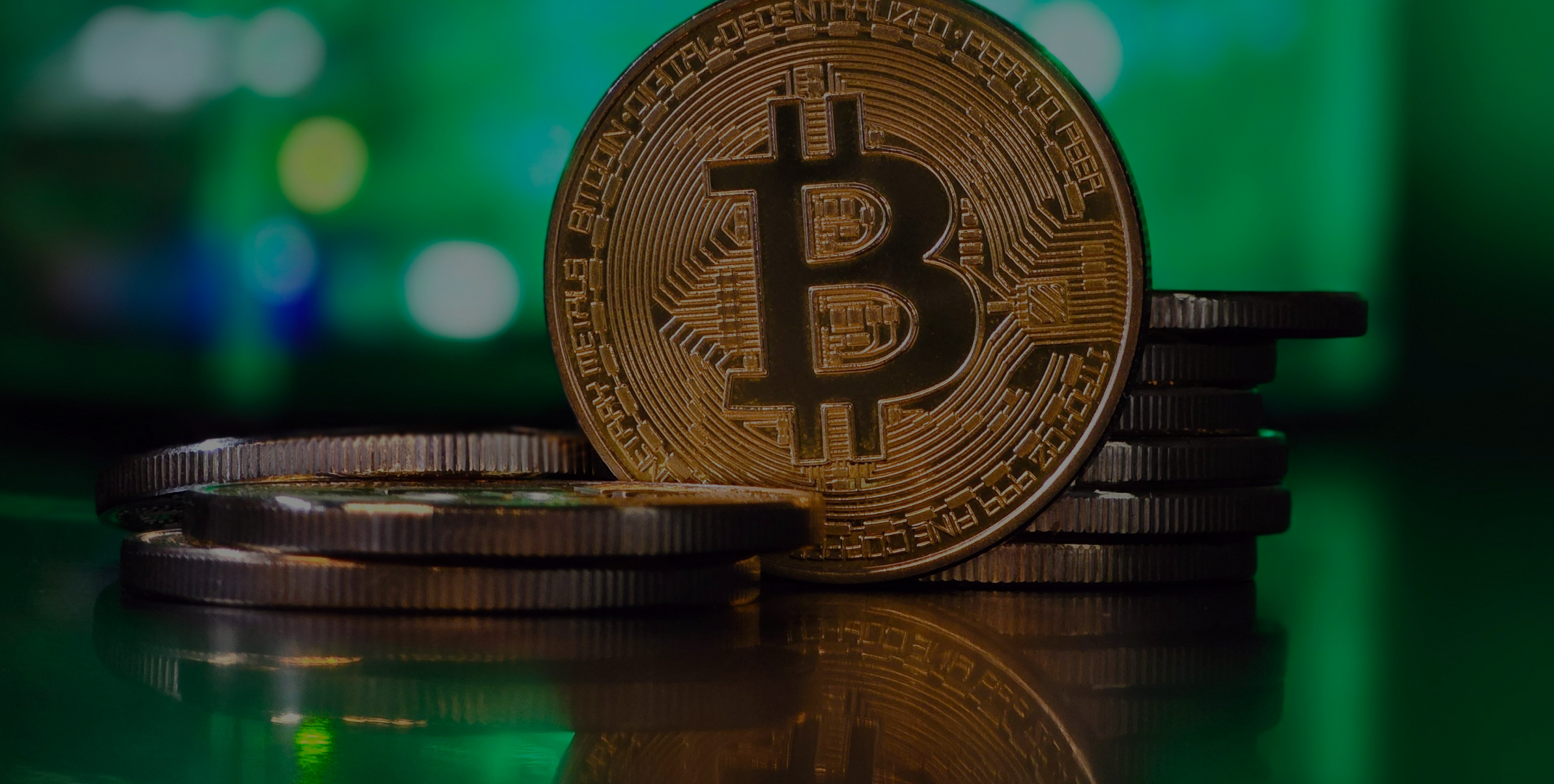 Bitcoin coin with stacked cryptocurrency on green background