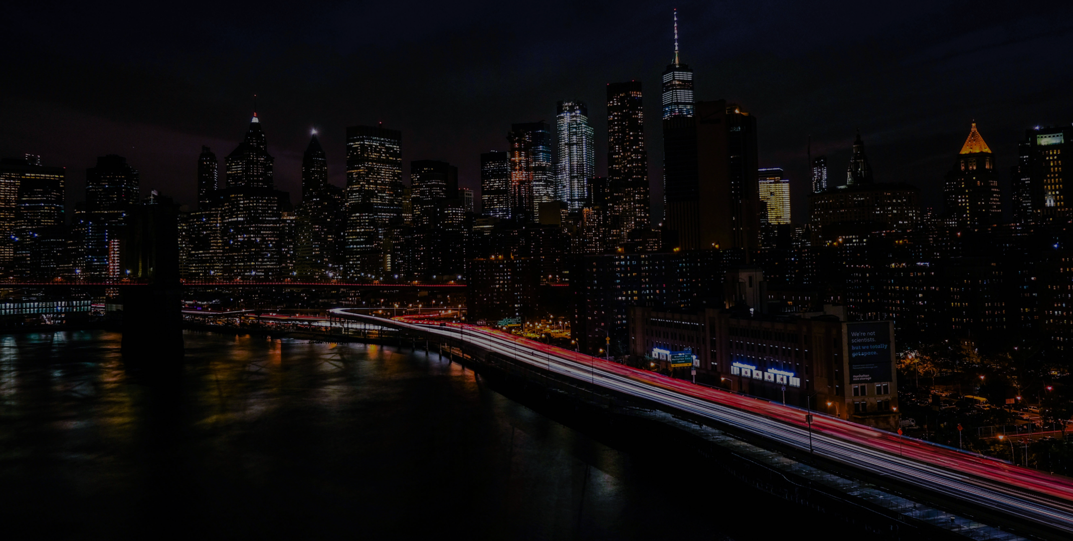 New York City skyline at night with traffic light trails